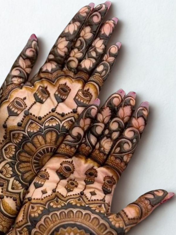 Bridal hands adorned with intricate Kalash-themed Mehndi design featuring traditional pot motifs, floral patterns, and detailed linework on the palms and fingers