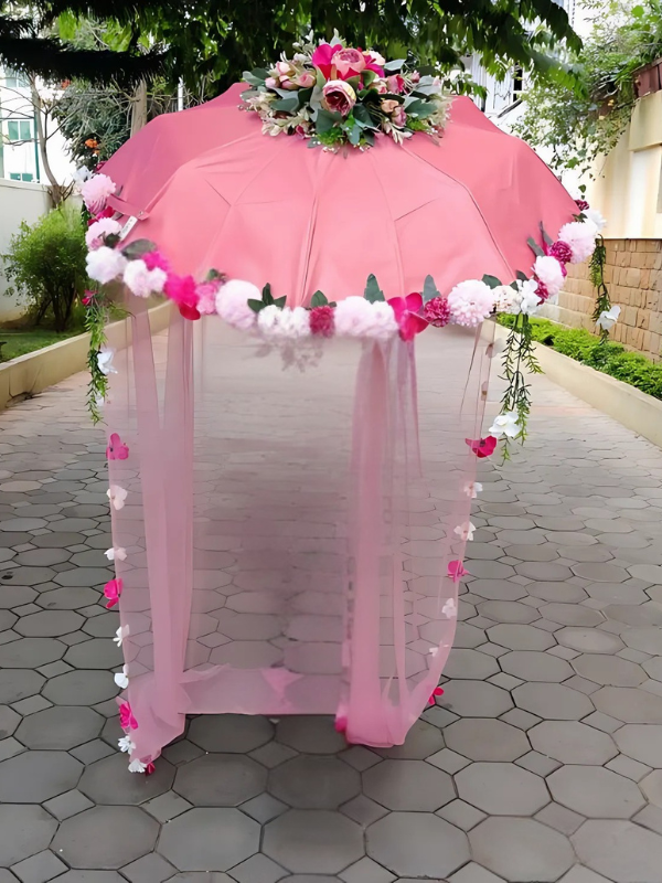 floral umbrella bridal entry in pink with veil covering umbrella from three sides