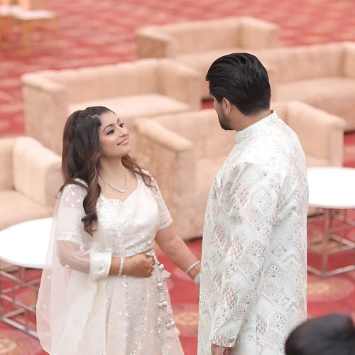engagement look with pastel green sherwani bride in complimenting ivory lehenga